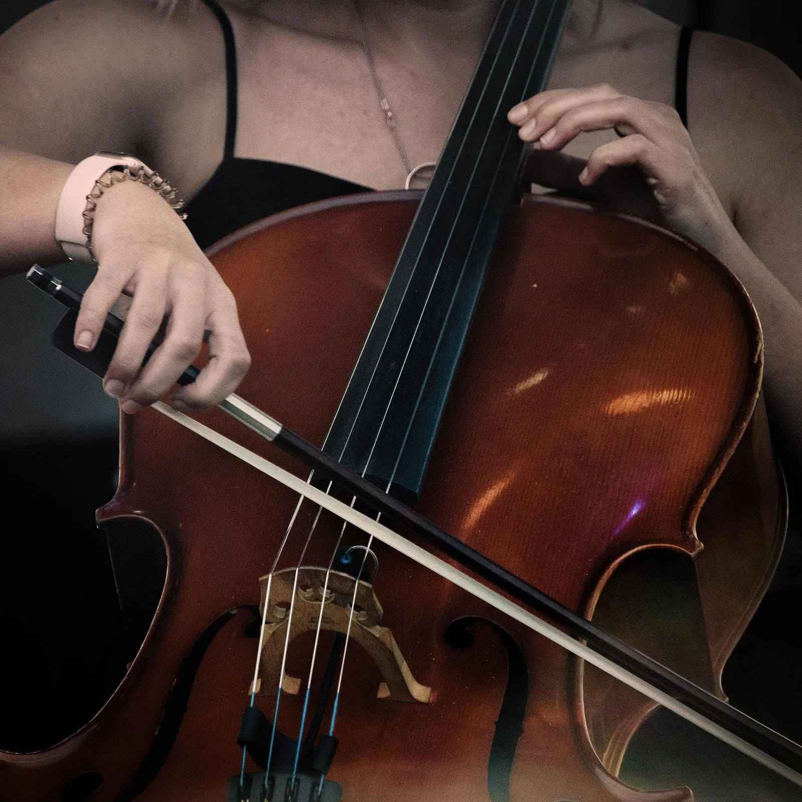 Close-up of a cellist's hands and bow during a performance