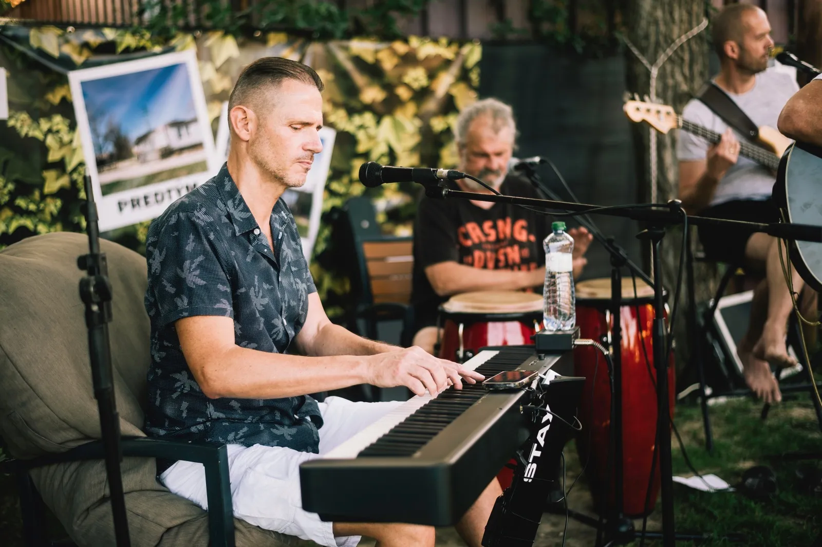 Milan Vodrážka playing stage piano with Ivan Čeredejev on guitar and vocals at Scherz Kafe